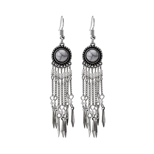 Detail of bohemian drop earrings with silver tassels, white marble stones and beads