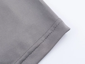 Macro shot of grey ribbed knit fabric texture and high-quality double-needle stitched hem