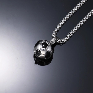 Detailed macro view of soccer ball pendant with polished silver finish and link chain
