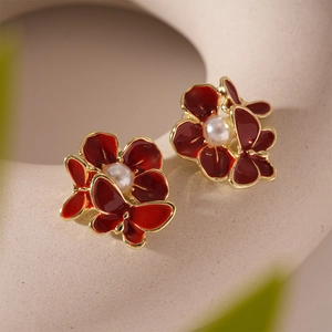 Elegant Ankara red flower stud earrings with pearl center and golden butterfly detail