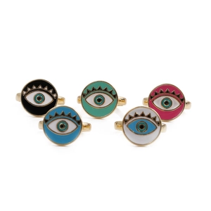 Detailed view of five evil eye open rings with colorful enamel discs and gold plating