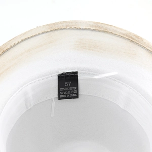 Detail of internal sweatband and size 57 polyester care label on the festive party hat
