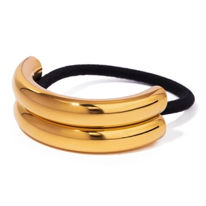 Detail of high-elastic black hair tie with gold mirrored stainless steel metal accents