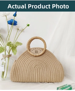 Detailed weave pattern of semi-circular woven tote bag on elegant white background
