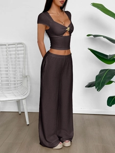 Detail of starfish metal buckle and cutout on brown ribbed two-piece set top