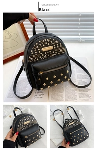 Detail of black punk mini backpack showing golden studs and lychee pattern leather