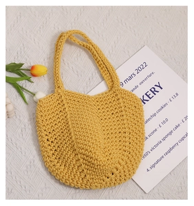 Close-up of yellow handmade crochet cotton tote bag with textured knit details