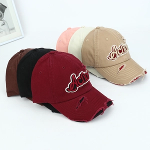 Detail showing various colors and distressed ripped texture of embroidered baseball caps