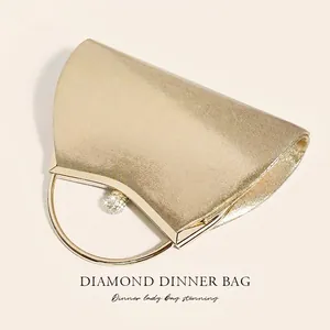 Elegant gold evening clutch bag with sparkling finish and diamond ring handle