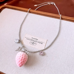 Macro shot of pink flocked strawberry pendant with zircon heart and star details