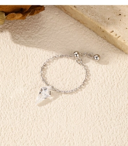 Detail of s925 silver adjustable chain ring with a clear geometric diamond pendant