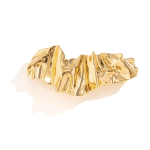 Golden irregular liquid metal hair clip with a modern crinkle geometric design on white background