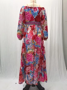 Detail view of colorful floral print and elegant flared skirt on a long evening dress