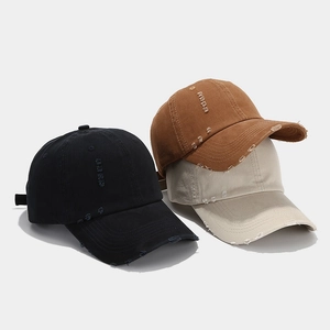 Distressed vintage baseball caps in black, brown and beige with worn-out hole details