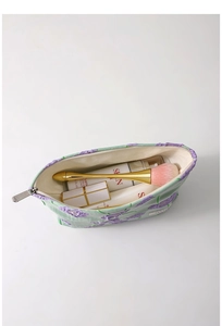 Top view of green floral canvas makeup bag with purple flowers showing interior storage space