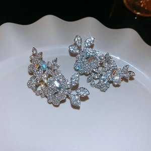 Detail of silver flower and leaf ear cuff featuring intricate diamond-like crystal pavé