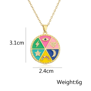 Detailed view of bohemian gold-plated pendant with enamel symbols and measurements