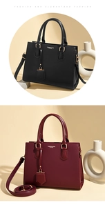 Detail of high-quality lychee grain leather texture and gold hardware on tote bag