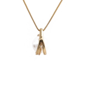 Minimalist gold necklace featuring an irregular geometric pendant with a white pearl