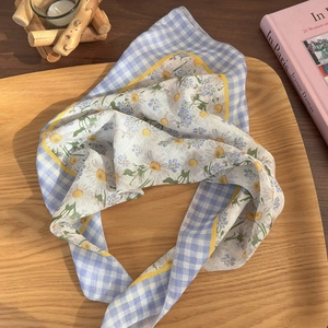 Floral cotton linen bandana with daisy print and blue checkered border on wooden tray