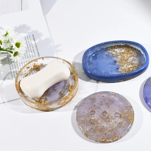Detailed view of the handmade oval resin soap dish with gold foil in a bright setting