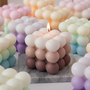 Gradient bubble cube aromatherapy candle in burning state for home interior decor