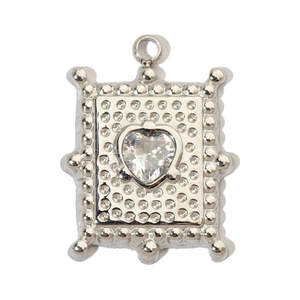 Detailed macro view of a silver rectangular steel pendant with heart-shaped zircon stone