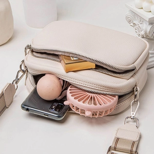 Chic beige large capacity shoulder bag with striped strap and soft pebble leather texture