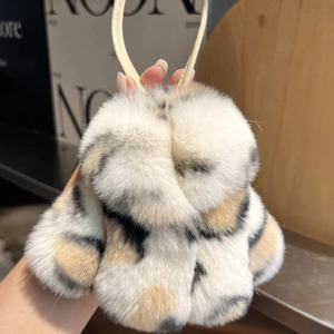 Detail of a mini leopard print fur coat keychain with soft texture and hanging loop