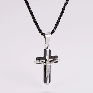 Detailed view of bicolor black and silver crucifix pendant with woven chain necklace