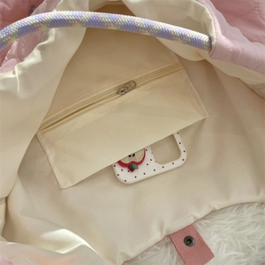Detailed interior of the pink quilted tote bag showing zipper pocket and soft lining