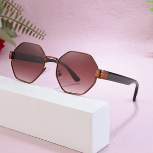 Octagonal polygon metal sunglasses with gradient brown lenses on geometric display