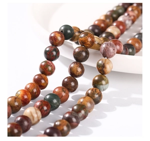 Detailed macro view of natural Picasso Jasper beads showing earthy marble patterns