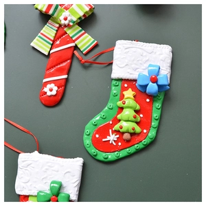 Detailed close-up of colorful resin Christmas ornaments including socks and candy canes