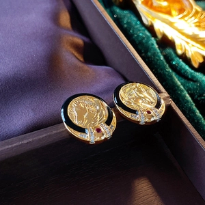 Detail shot of vintage horse-head relief earrings with black enamel and zircon accents
