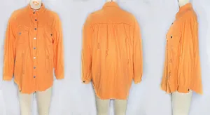 Detail showing bright orange denim jacket with frayed edges and distressed ripped patterns
