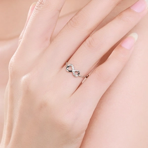 Adjustable sterling silver infinity ring with micro-pave zircon on a model hand