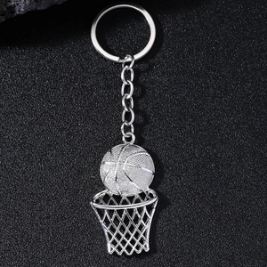 Detail view of a hollow basketball hoop and ball pendant keychain in silver finish