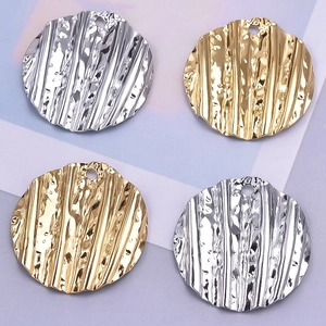 Detailed view of round corrugated 304 stainless steel pendants for DIY necklace jewelry