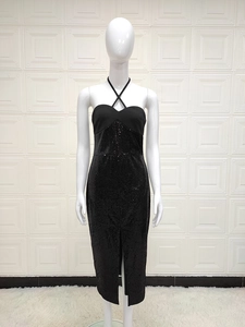 Detailed macro shot of shimmering black sequins on halter neck slit midi dress