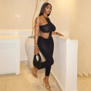 Chic black halter jumpsuit with waist cut-outs and slim fit for elegant street style