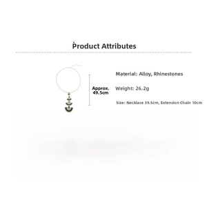 Detail of gold fan-shaped pendant necklace featuring green rhinestones and tassel accents