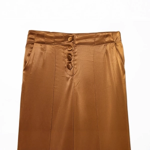 High waist bronze satin wide leg trousers with decorative button closure details