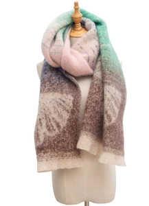 Macro detail of multicolored gradient knit scarf with fringe trim and leaf pattern textures