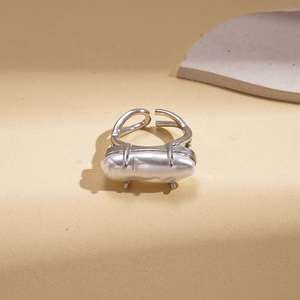Macro view of silver double-layered open ring with baroque pearl and minimalist prongs