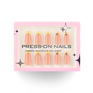French yellow press-on nails with 3D cherry patterns in a pink display case