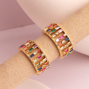 Luxurious wide gold band ring set with rows of colorful baguette cubic zirconia and diamonds