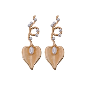 Golden vine earrings with small pearls and large oval pearl centerpiece on white background