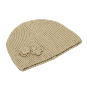 Detail view of beige ribbed knit beanie with crochet flower accents and wool texture