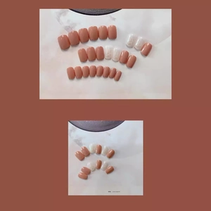 Faux ongles courts nude shell avec texture marbre et finition rouge brique sur cartes